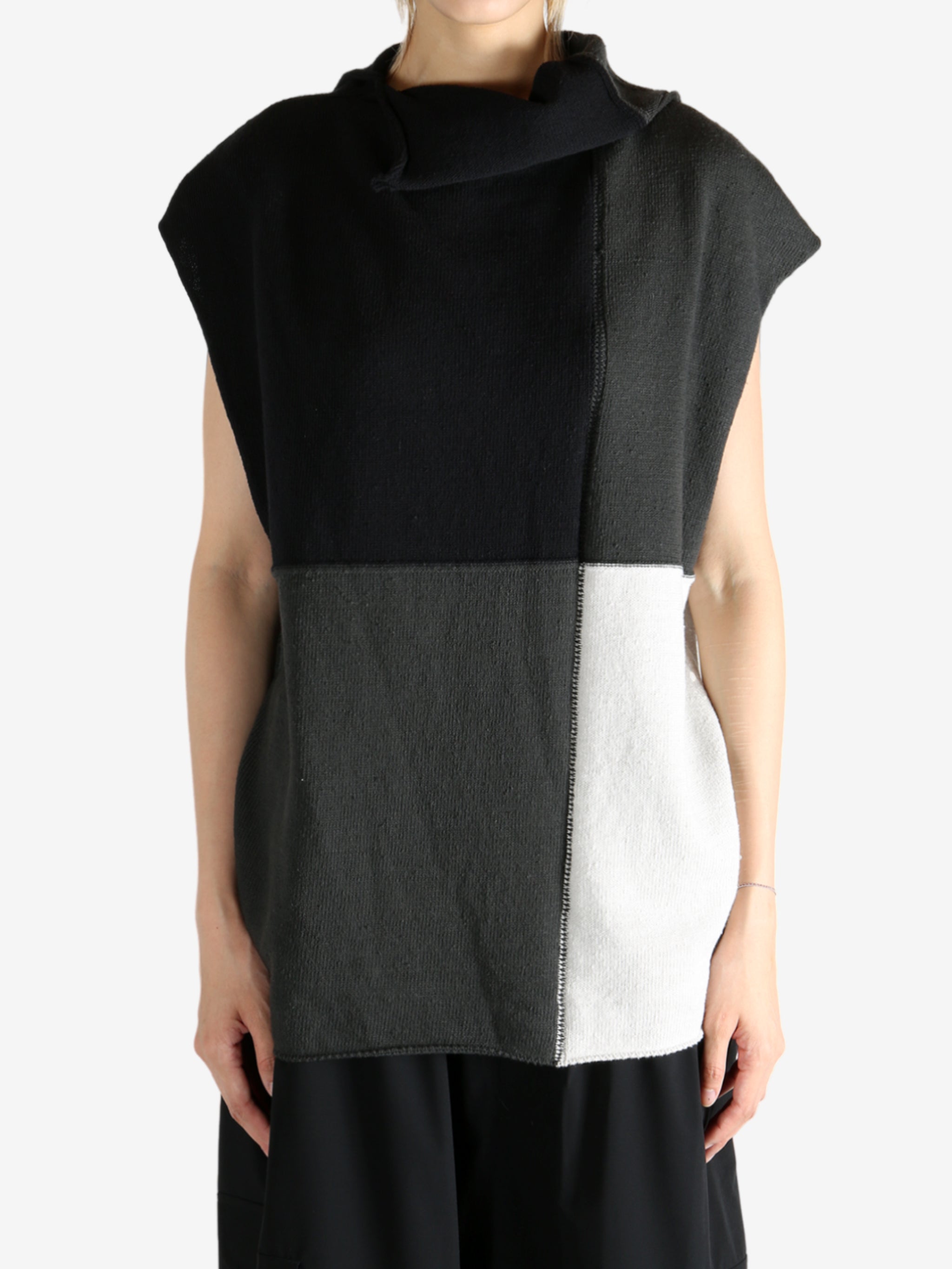 Black top worn by a person, showing the top fit