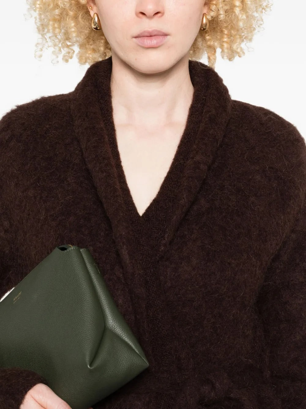 Close up of brown knitwear, showing texture of the blend fabric