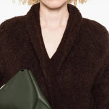 Close up of brown knitwear, showing texture of the blend fabric