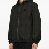 Black jacket worn by a person, showing the jacket fit