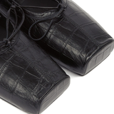 Close up of black shoes, showing texture of the leather fabric