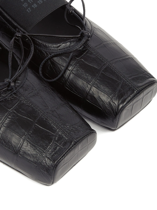 Close up of black shoes, showing texture of the leather fabric