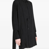 Black shirt worn by a person, showing the shirt fit