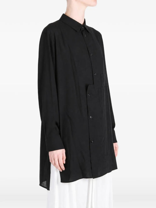 Black shirt worn by a person, showing the shirt fit