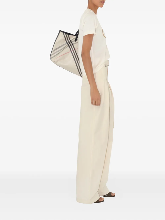 Tan top worn by a person, showing the top's fit