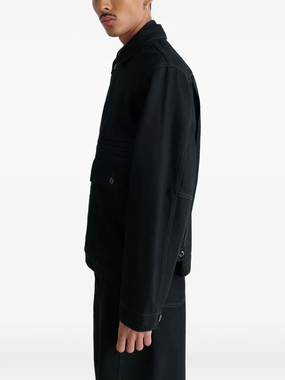 Black jacket worn by a person, showing the jacket fit