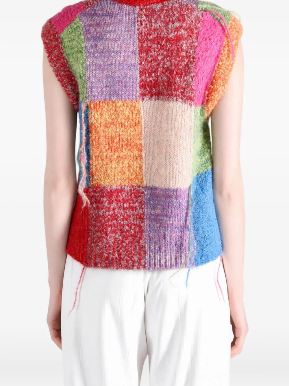Red knitwear worn by a person, showing the knitwear fit