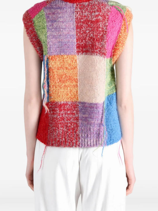 Red knitwear worn by a person, showing the knitwear fit