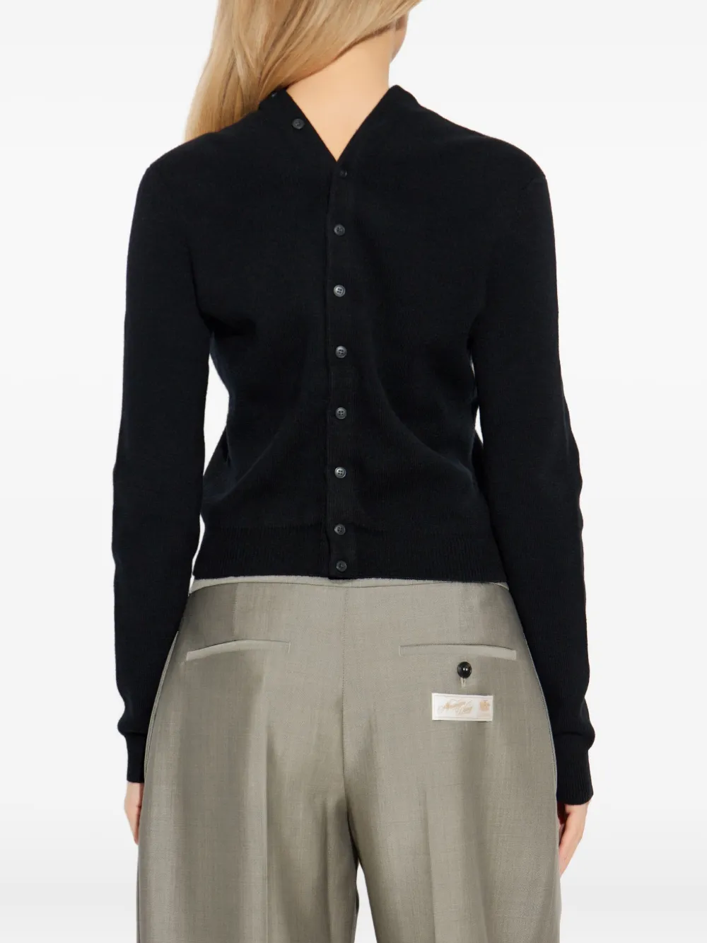 black knitwear worn by a person, showing the bag fit