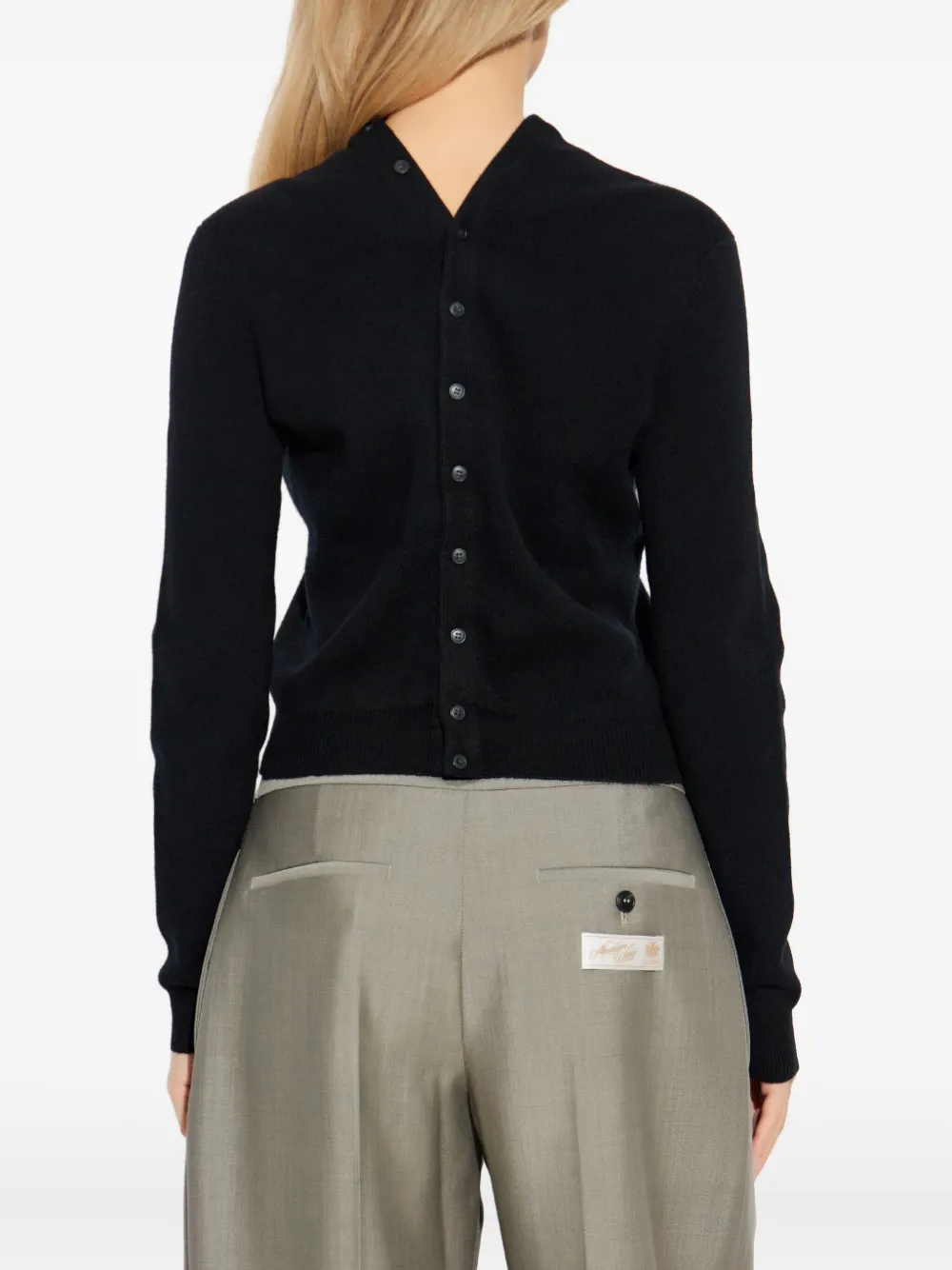 black knitwear worn by a person, showing the knitwear fit