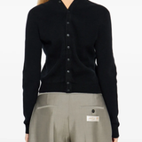 black knitwear worn by a person, showing the knitwear fit