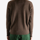 Brown knitwear worn by a person, showing the knitwear's fit