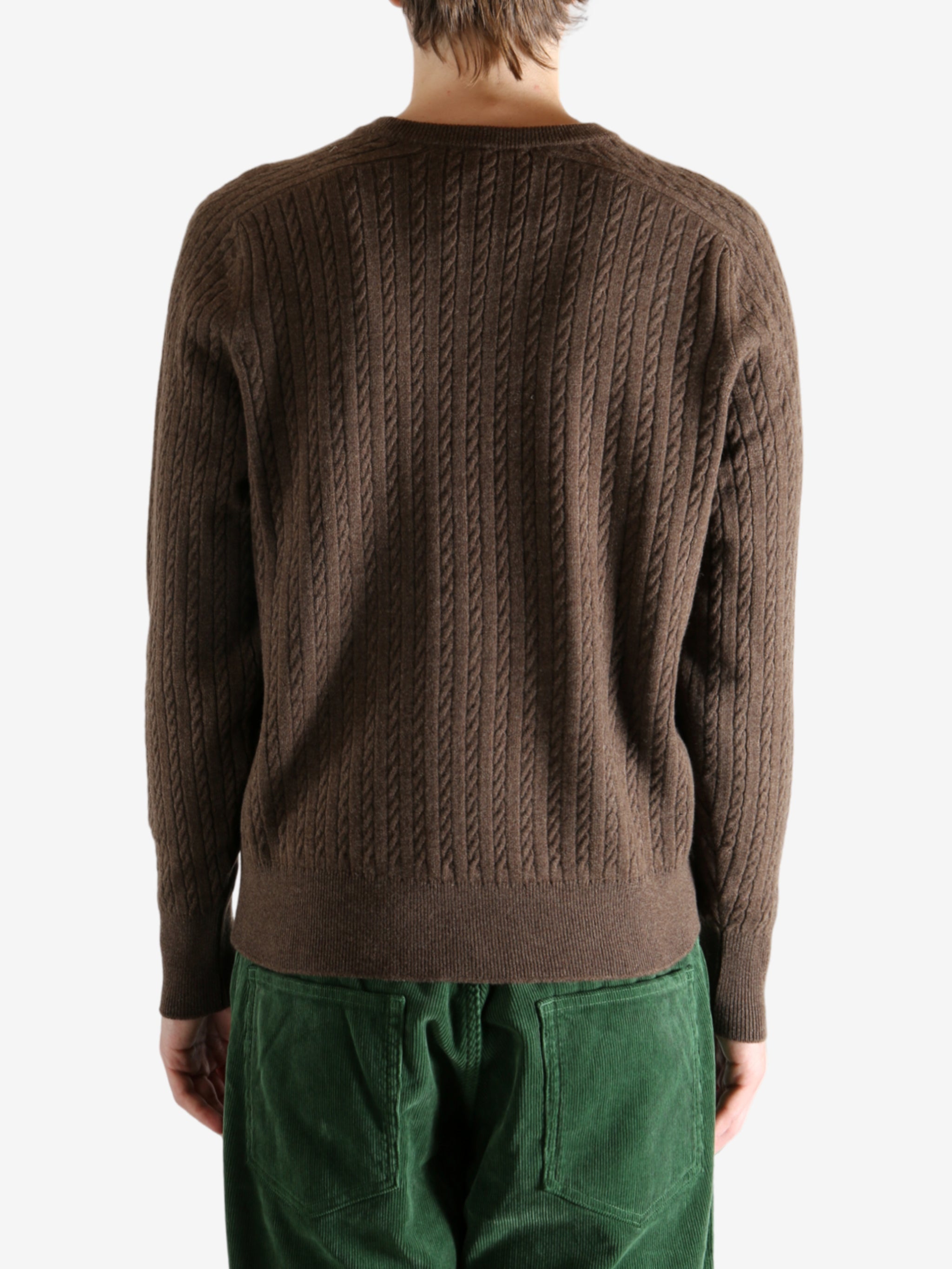 Brown knitwear worn by a person, showing the knitwear's fit