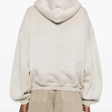 Tan hoodie worn by a person, showing the hoodie fit