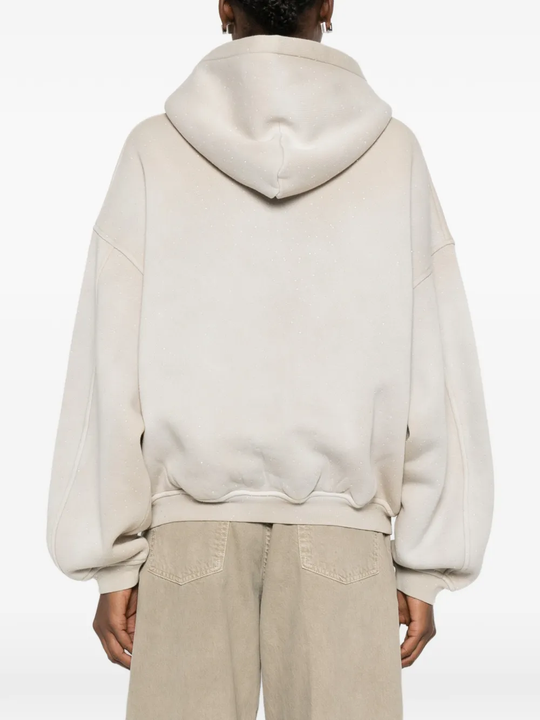 Tan hoodie worn by a person, showing the hoodie fit