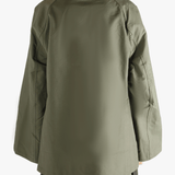 Green coat worn by a person, showing the loose fit.