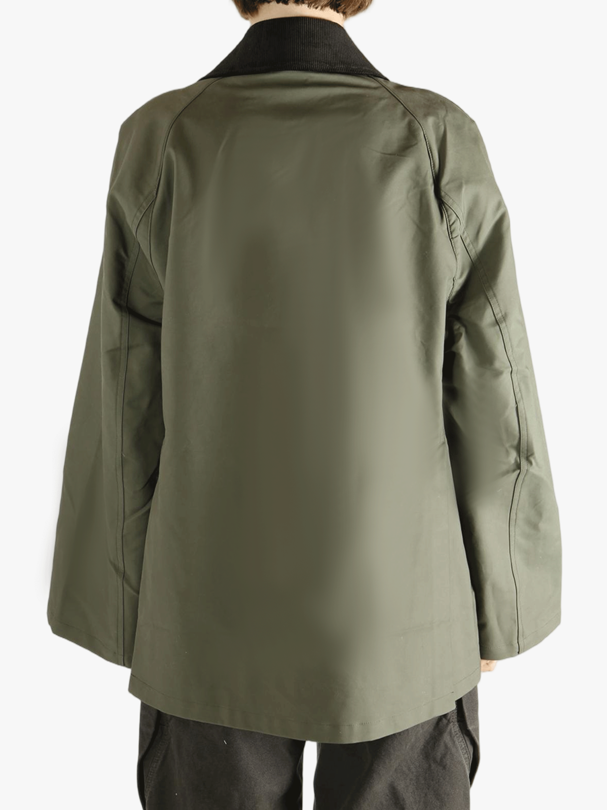 Green coat worn by a person, showing the loose fit.