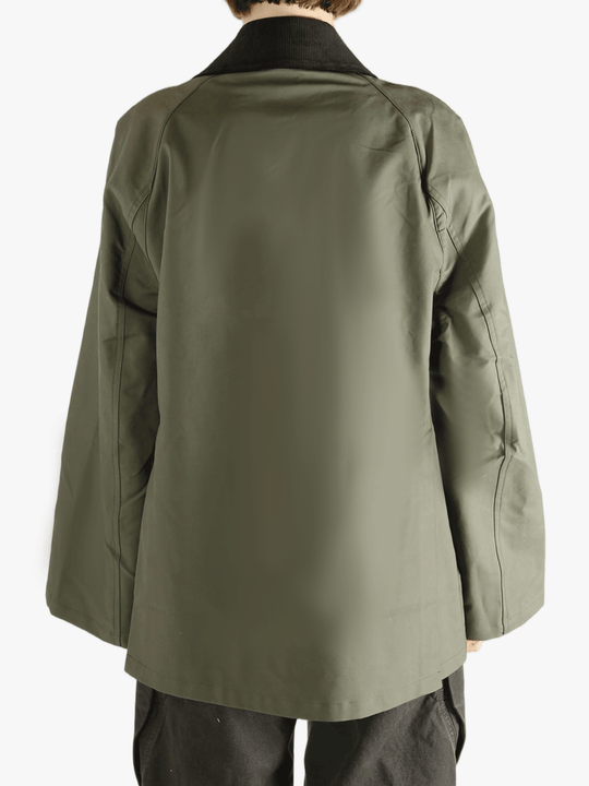 Green coat worn by a person, showing the loose fit.