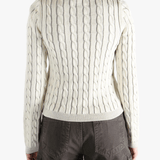 White knit long sleeve worn by a person, showing the loose fit.
