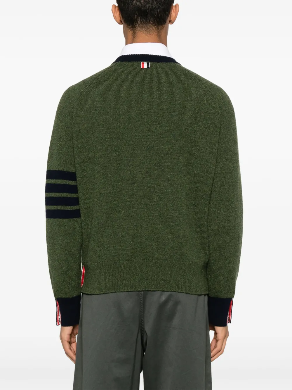 green knitwear worn by a person, showing the knitwear fit