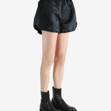 Black shorts worn by a person, showing the short's fit