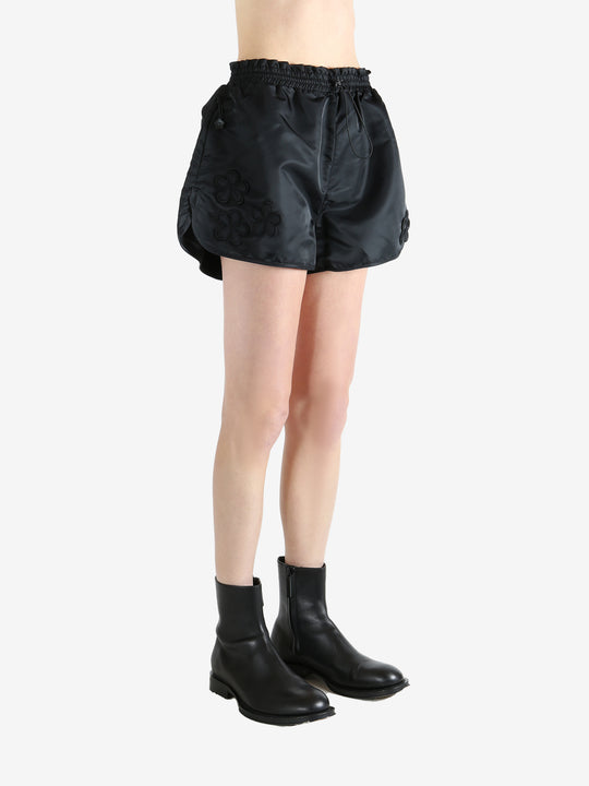 Black shorts worn by a person, showing the short's fit