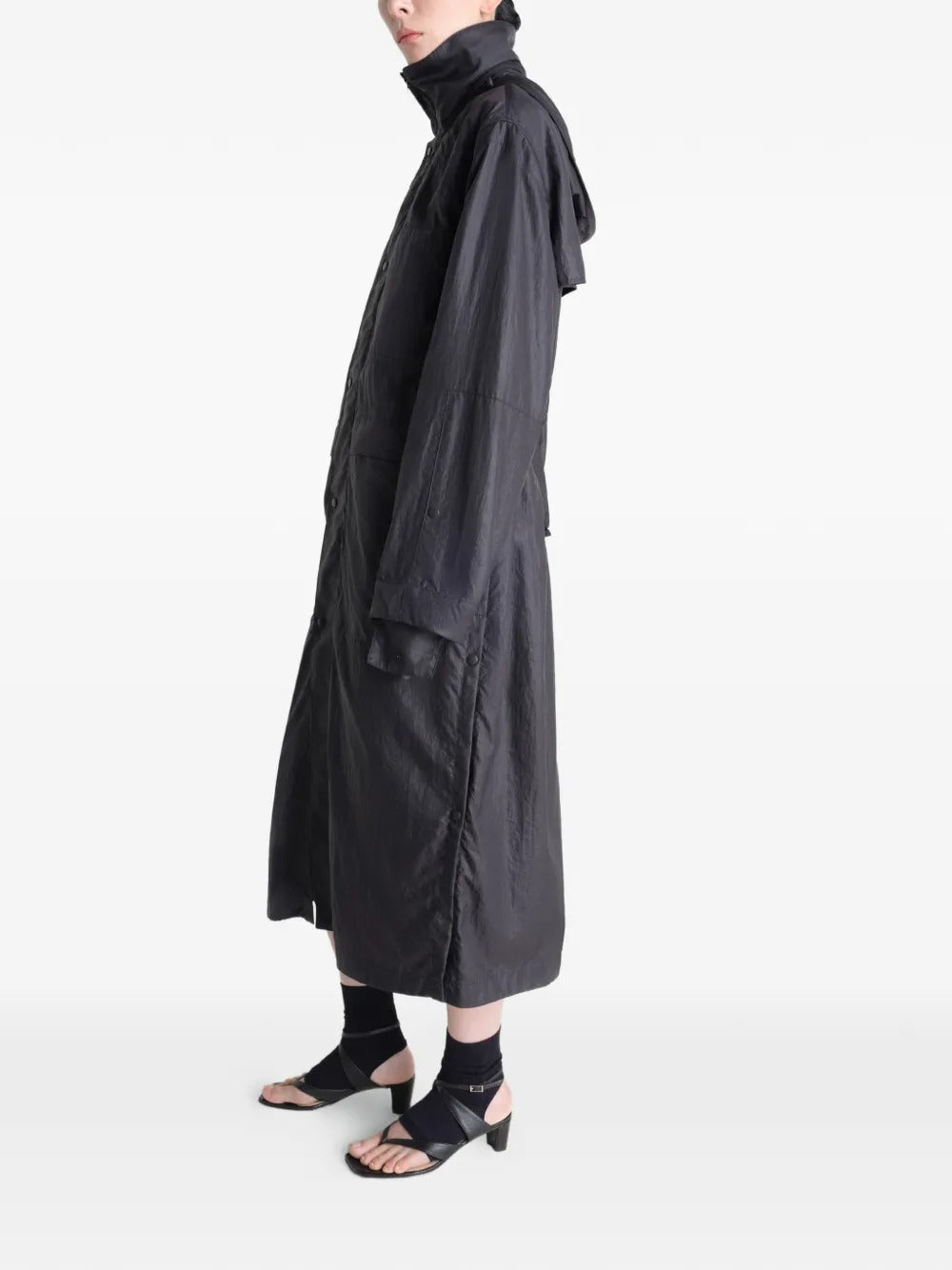 Black coat worn by a person, showing the coat's fit