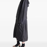 Black coat worn by a person, showing the coat's fit