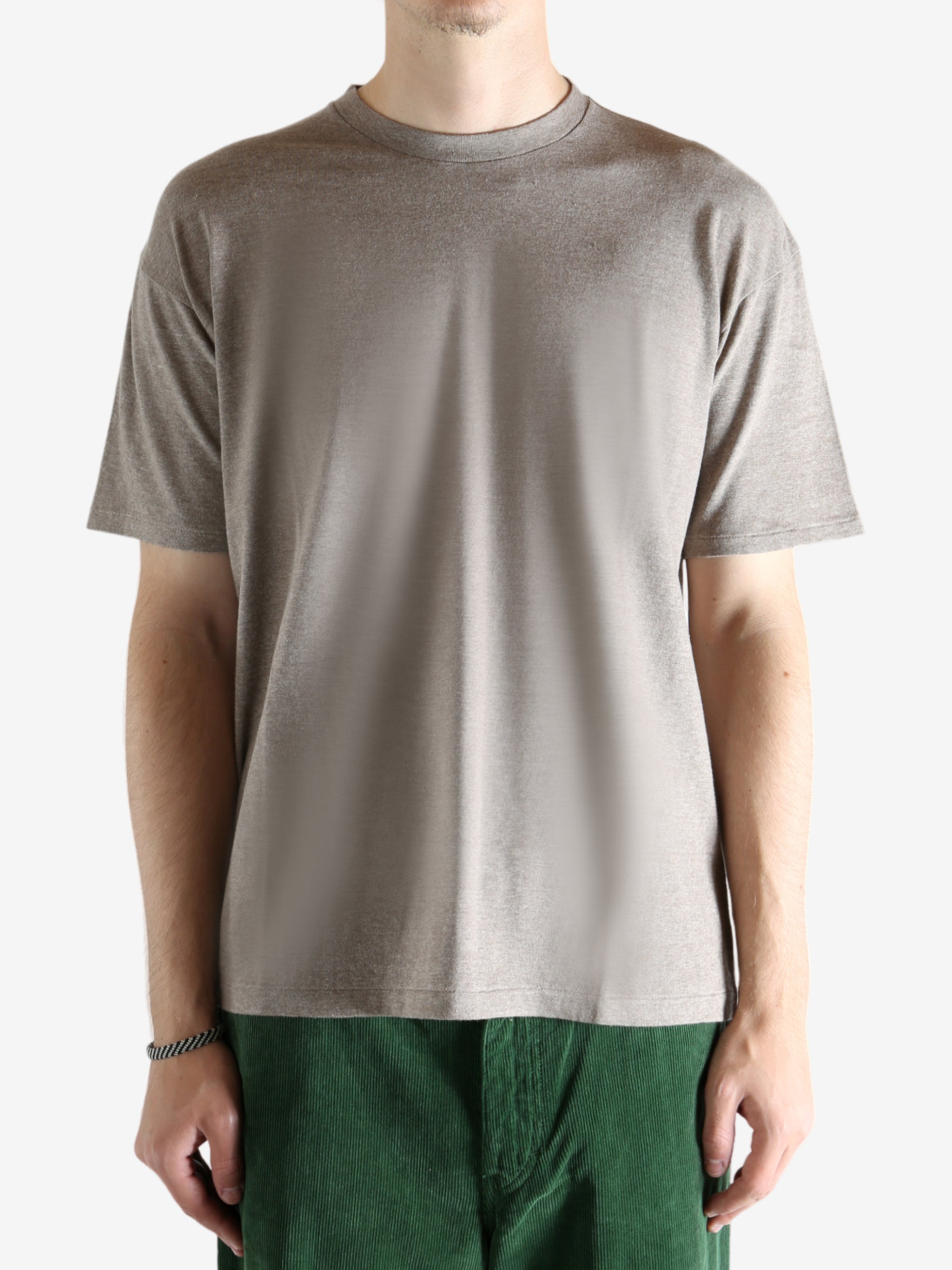 Brown t-shirt worn by a person, showing the shirt's fit
