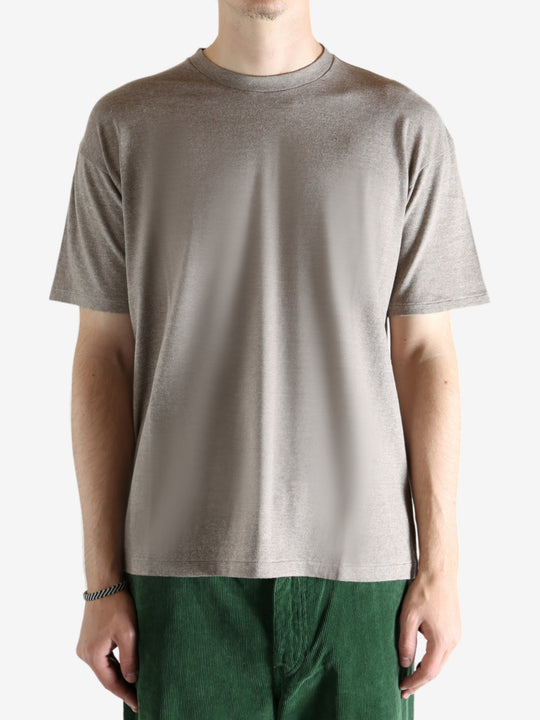 Brown t-shirt worn by a person, showing the shirt's fit