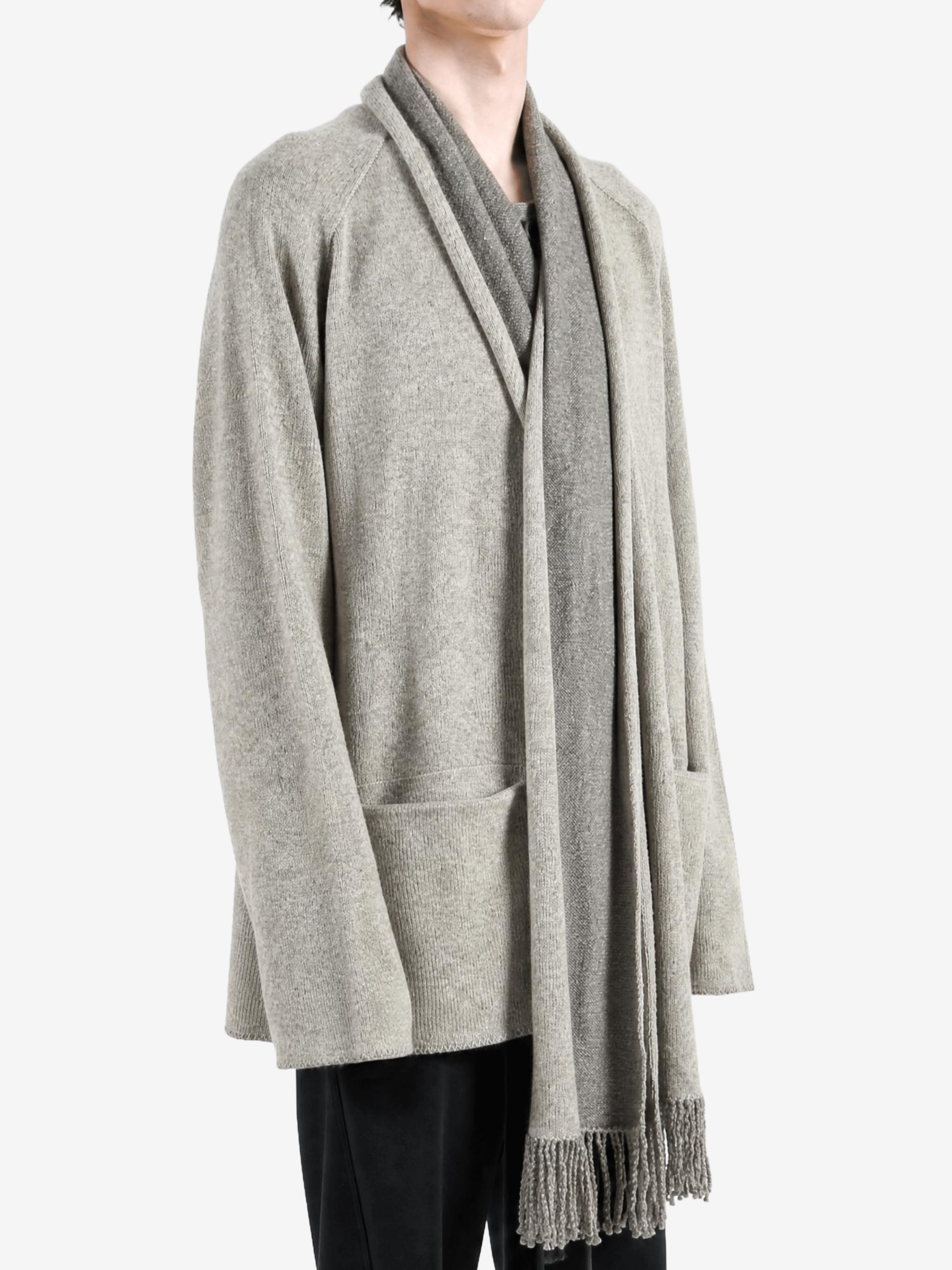 Grey knitwear worn by a person, showing the knitwear fit