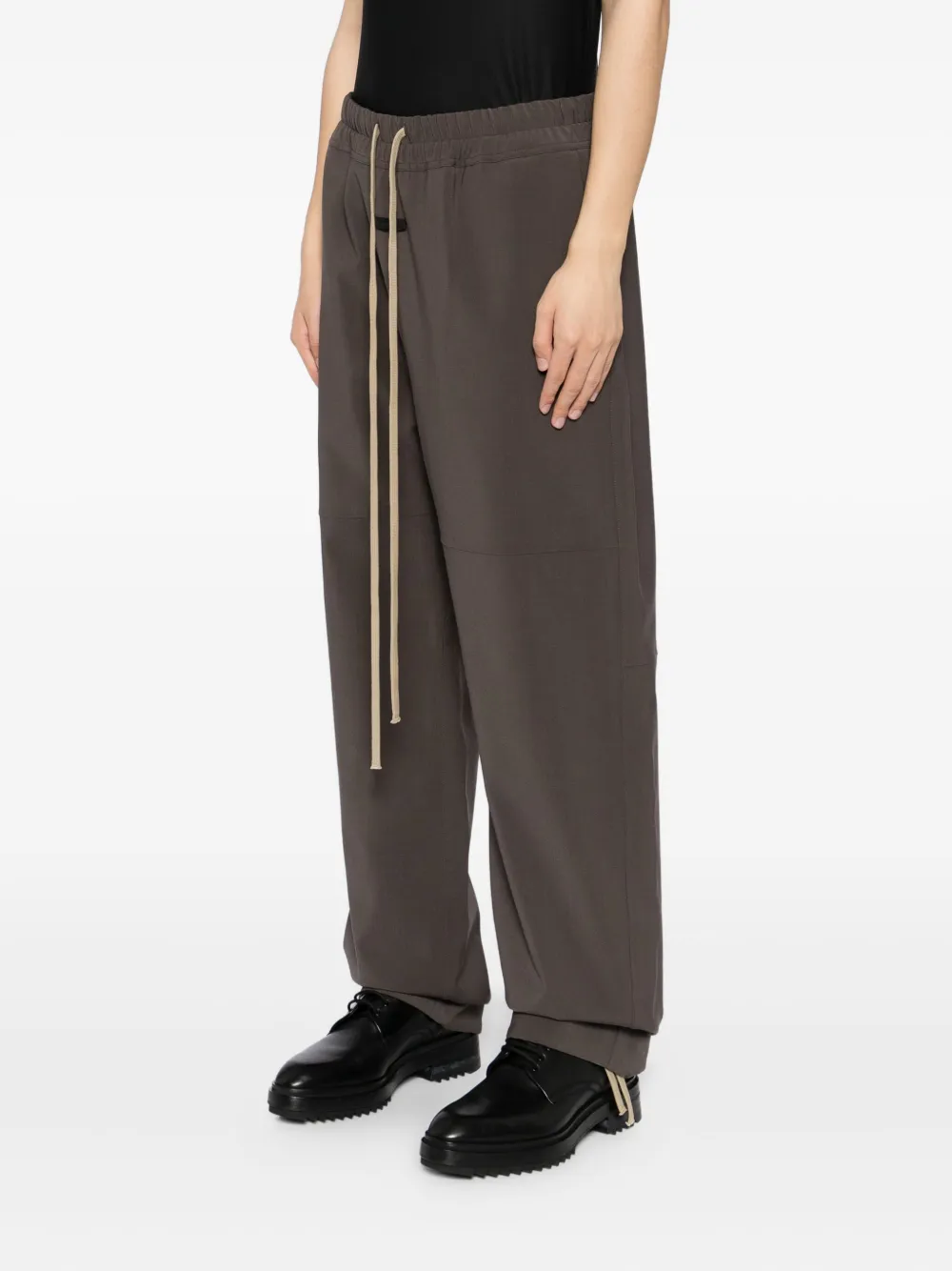 Brown pants worn by a person, showing the pants fit