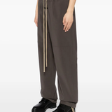 Brown pants worn by a person, showing the pants fit