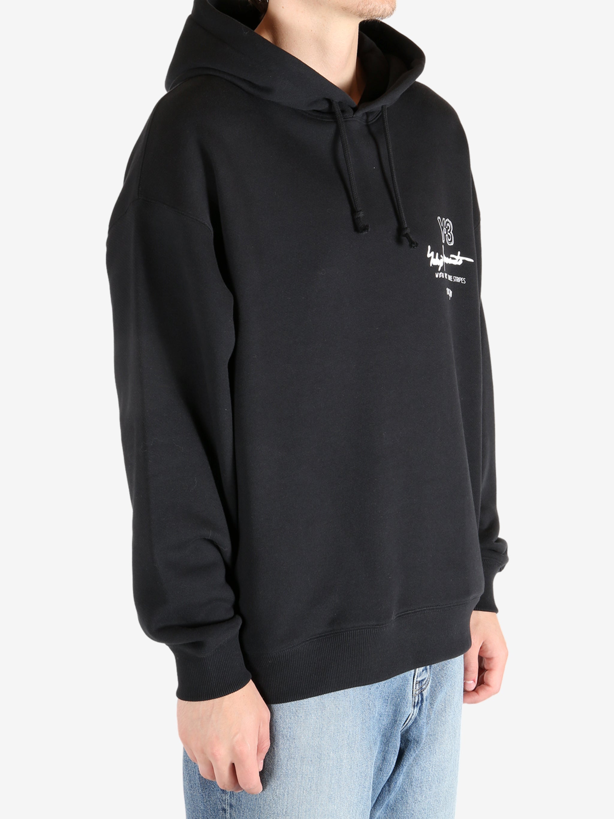 Black hoodie worn by a person, showing the hoodie's fit