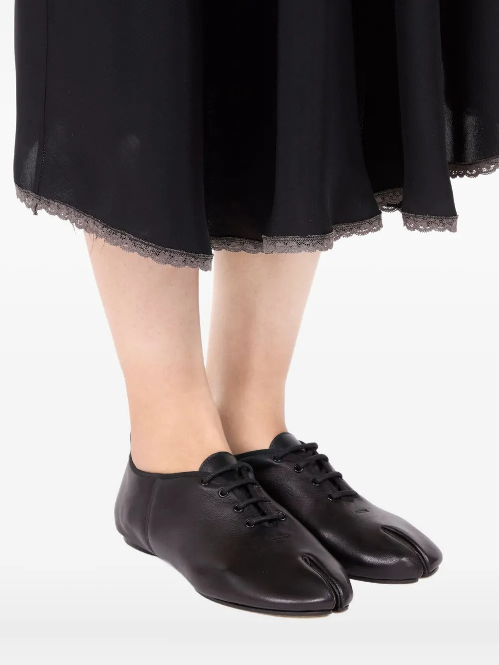 Black shoes worn by a person, showing the shoes' fit