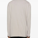 White t-shirt worn by a person, showing the shirt's fit