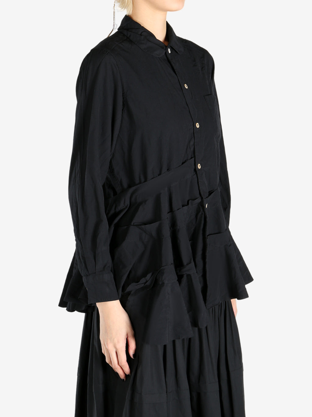 Black skirts worn by a person, showing the skirts fit