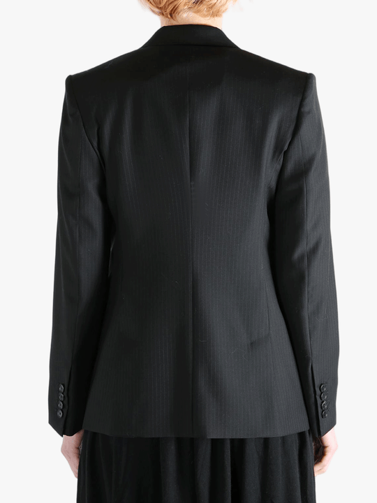 Black jacket worn by a person, showing the jacket's fit