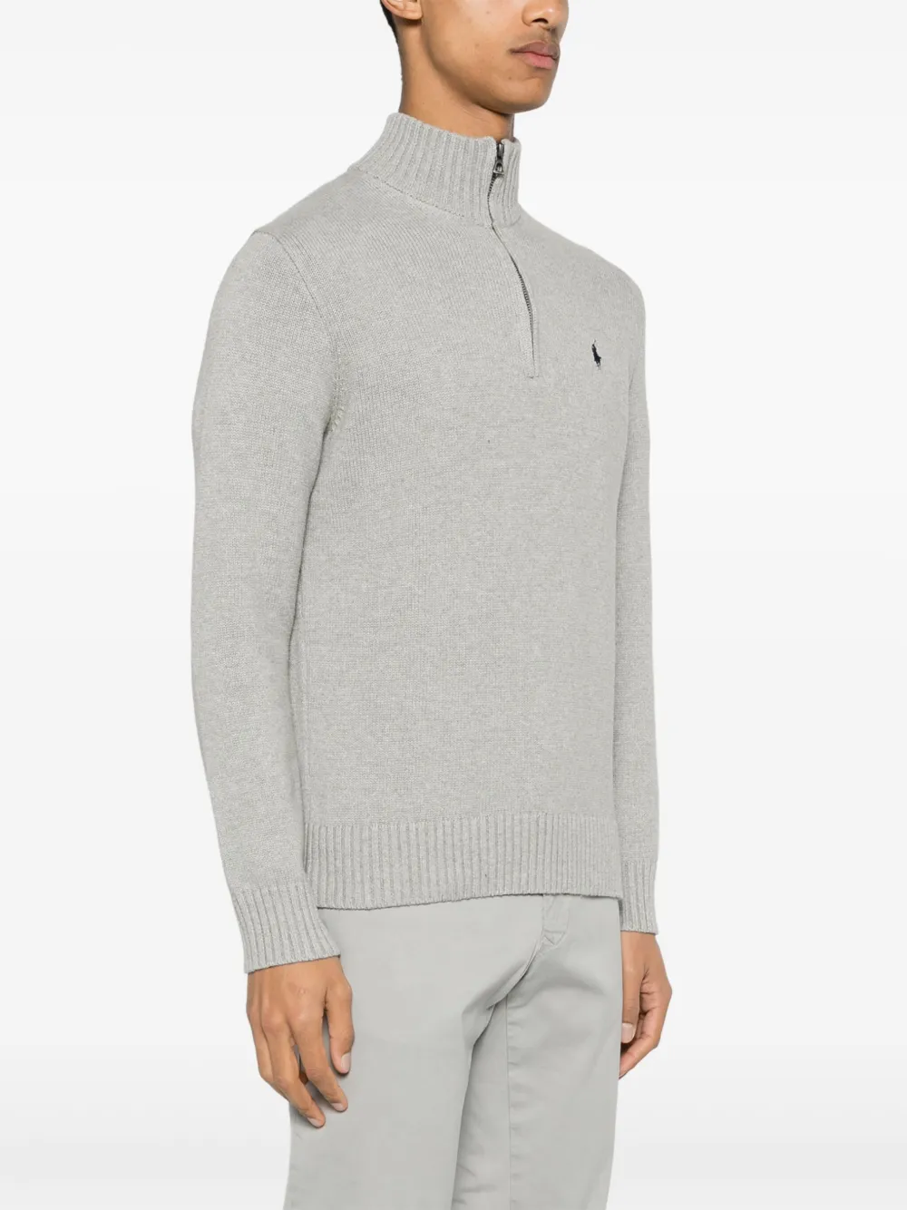 Grey knitwear worn by a person, showing the knitwear fit