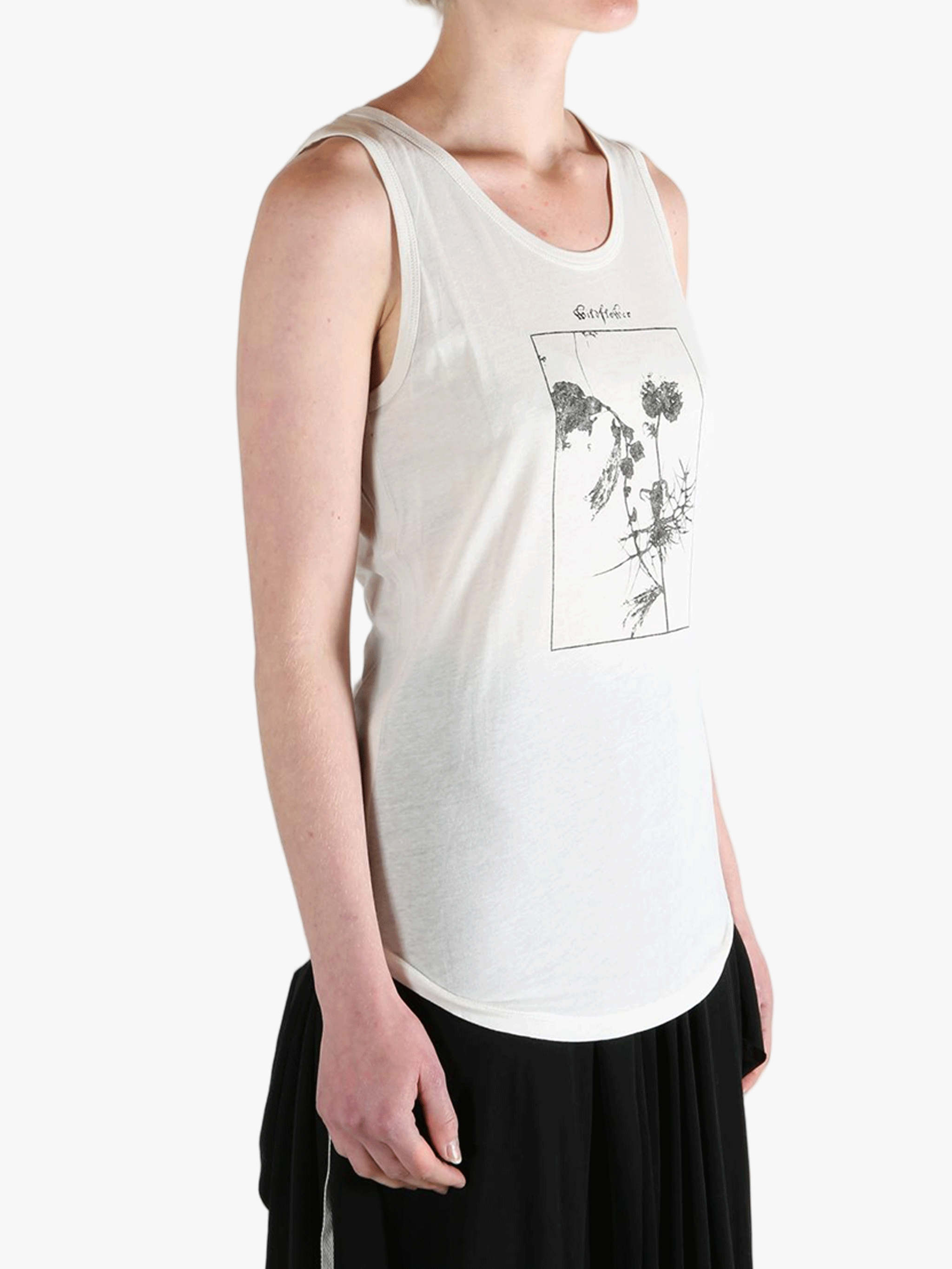 White top worn by a person, showing the top's fit