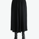 Black skirt worn by a person,showing the skirt fit