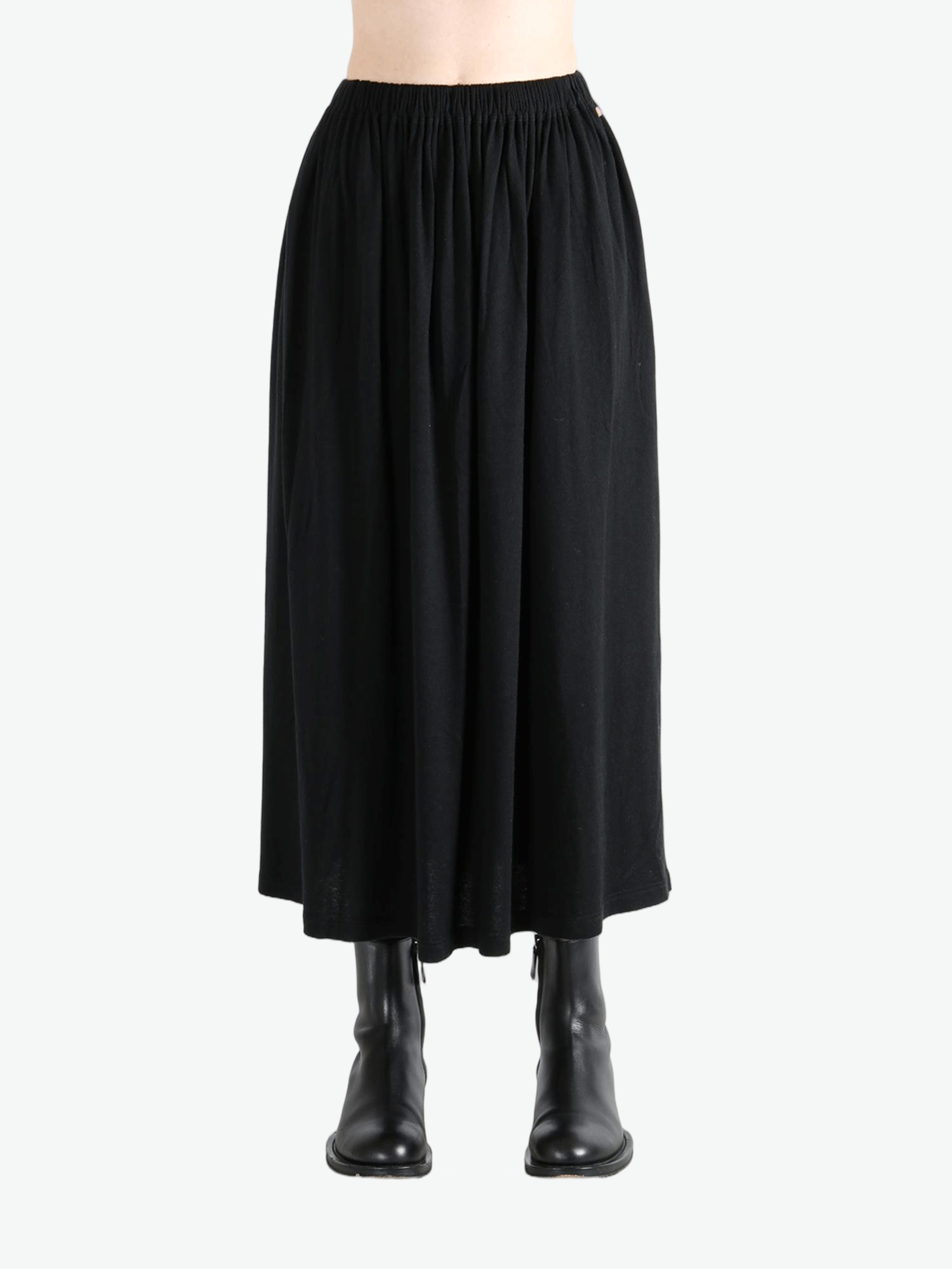 Black skirt worn by a person,showing the skirt fit
