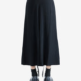 Black pants worn by a person, showing the pants' fit