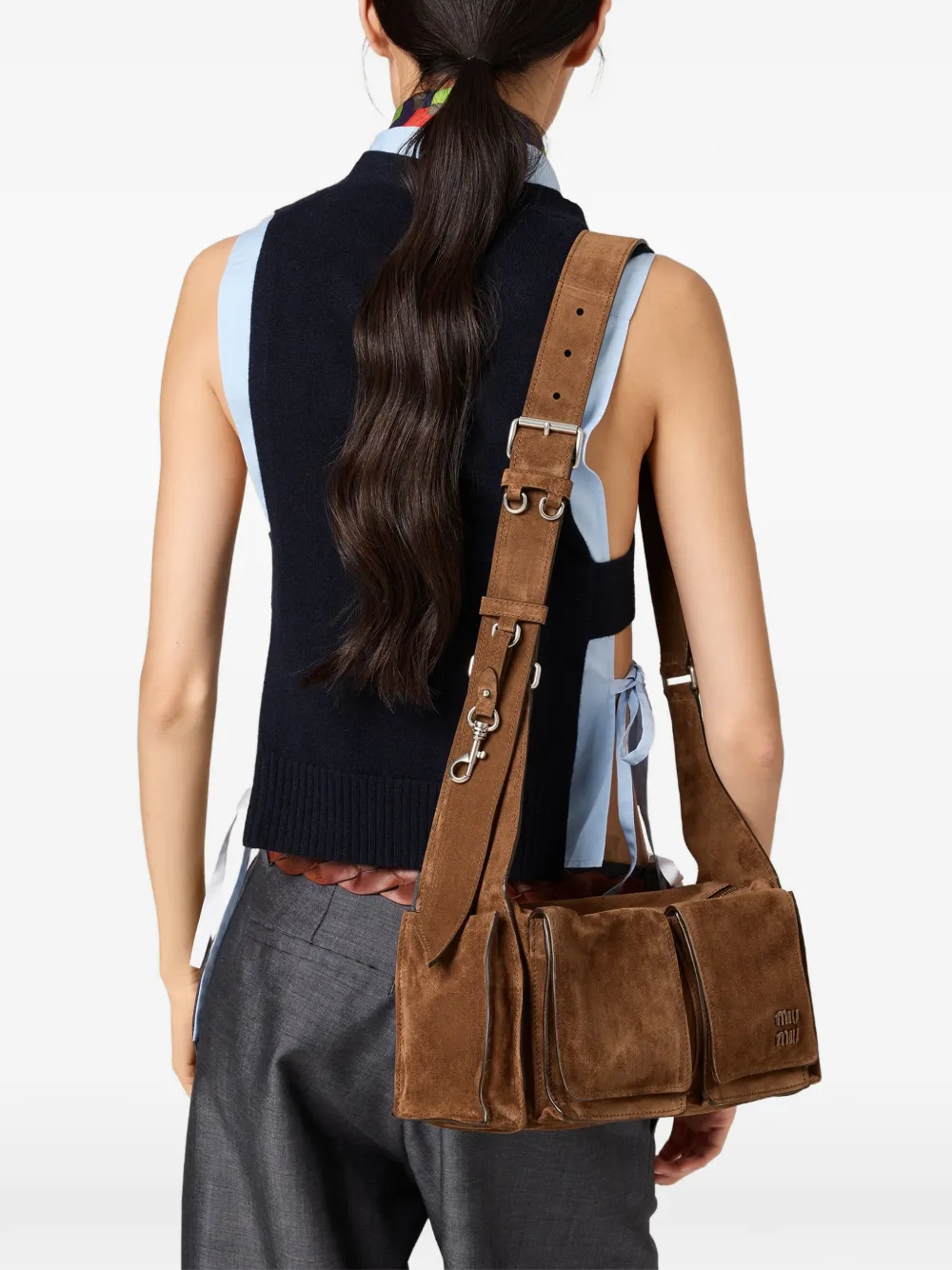 Brown leather bag worn by a person, showing the bag fit