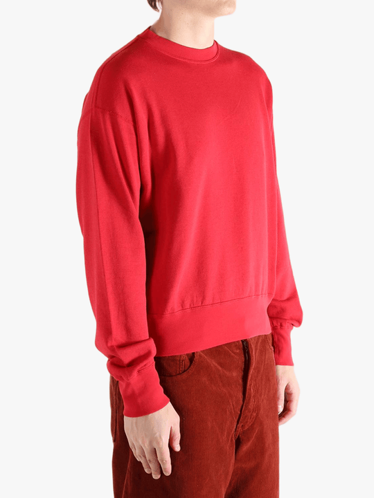 Red knitwear worn by a person, showing the knitwear's fit
