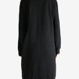 Black coat worn by a person, showing the coat's fit