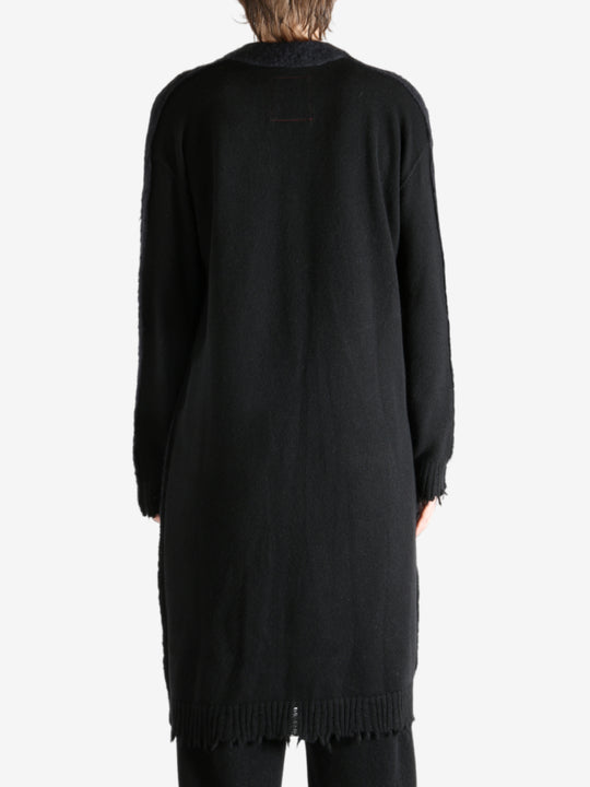 Black coat worn by a person, showing the coat's fit