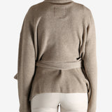 Tan cardigan worn by a person, showing the cardigan's fit