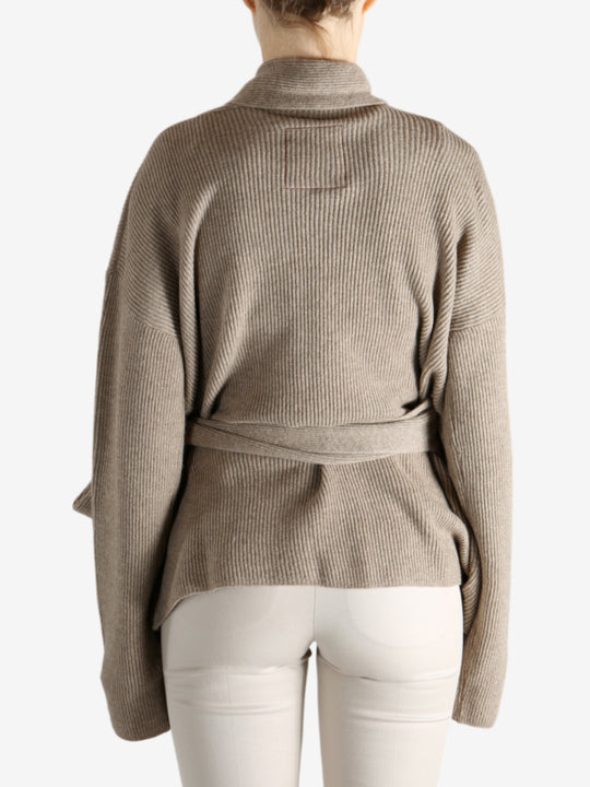 Tan cardigan worn by a person, showing the cardigan's fit