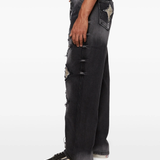 black jeans worn by a person, showing the jeans fit